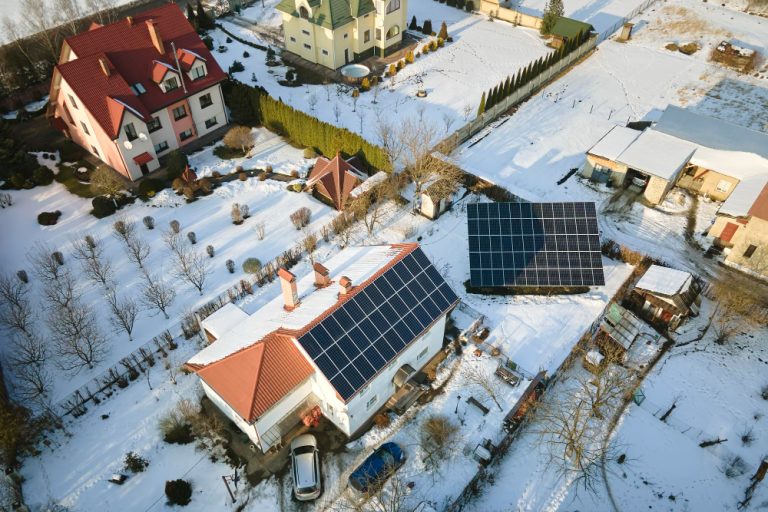 aerial-view-house-roof-with-solar-panels-covered-with-snow-melting-down-winter-end-producing-clean-energy-concept-low-effectivity-renewable-electricity-northern-region